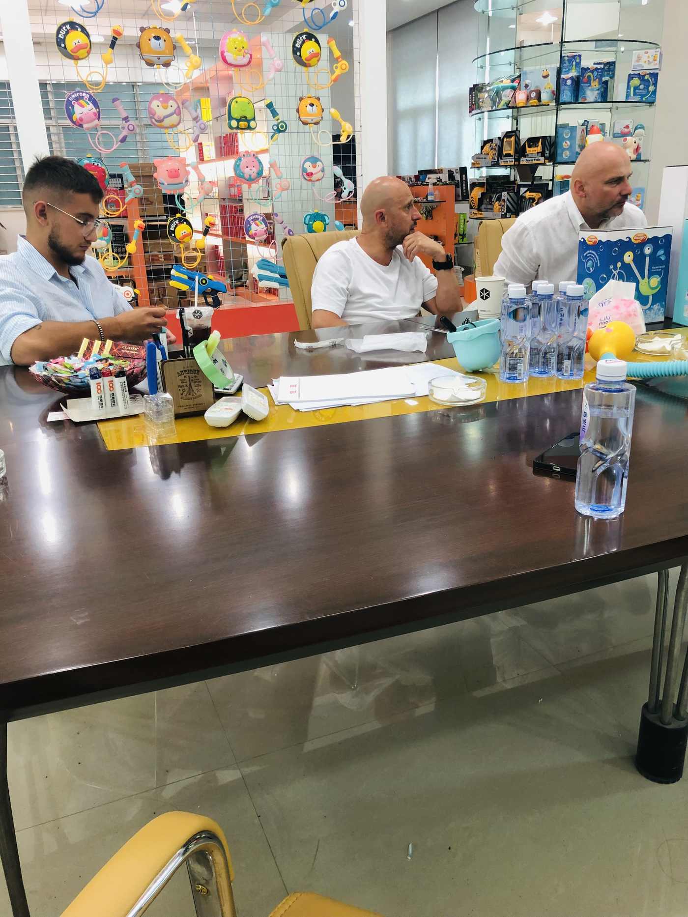 Buyers reviewing outdoor toy samples at the showroom table