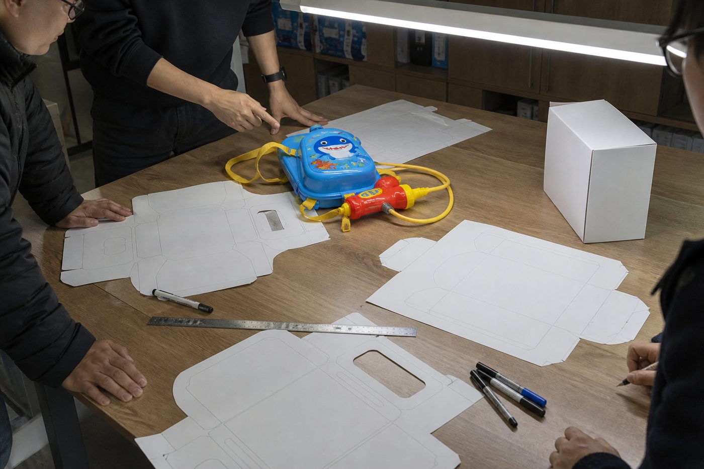 Packaging dieline and sample product on the artwork review table
