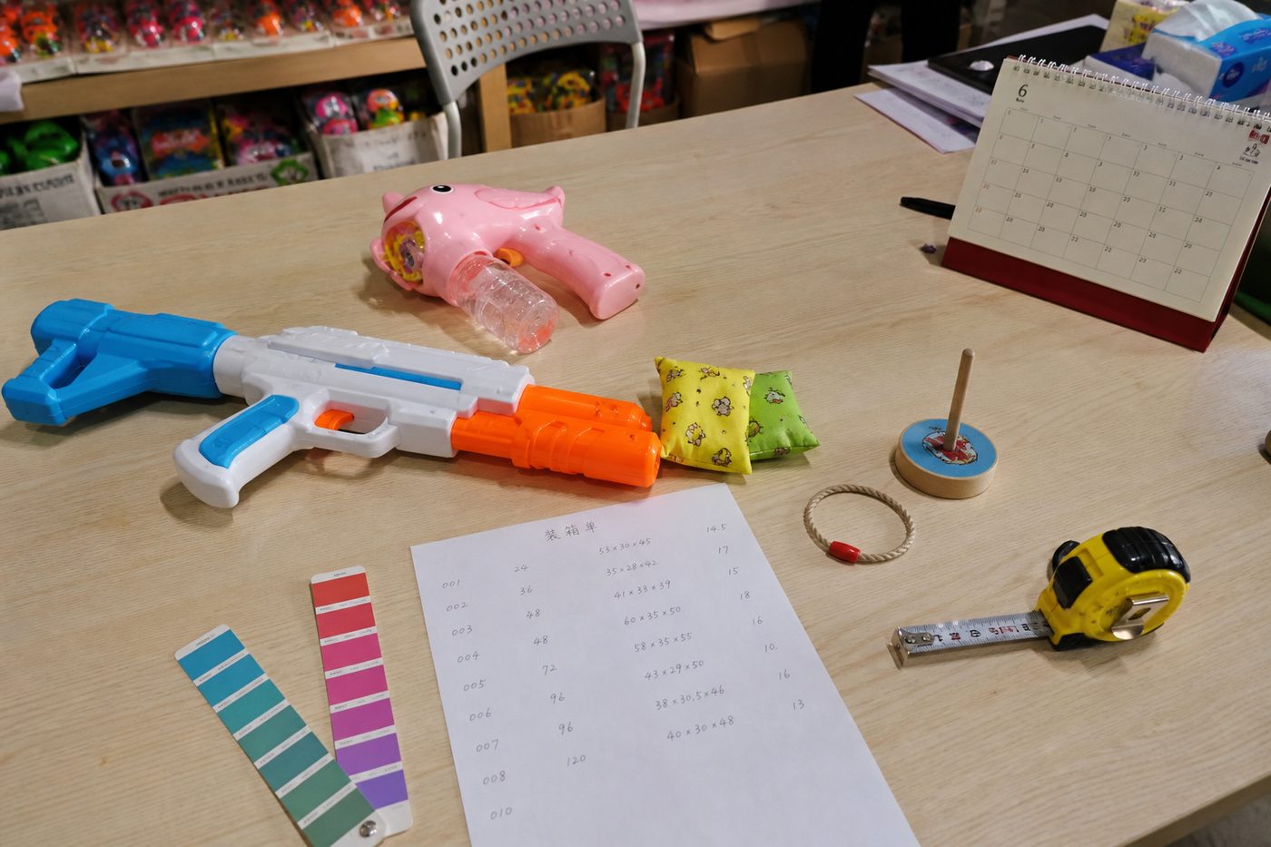 Outdoor toy samples and packing notes on a range-planning table